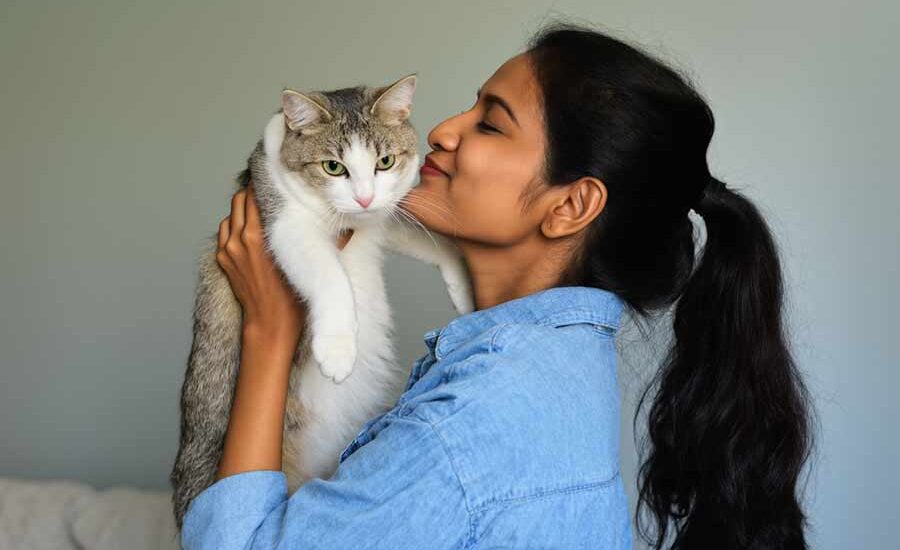 Manfaat Memiliki Hewan Peliharaan di Rumah untuk Kesehatan Ilustrasi seorang perempuan dan kucing peliharaannya (foto: Generatif AI)